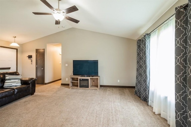 unfurnished living room featuring vaulted ceiling, ceiling fan, carpet flooring, and baseboards