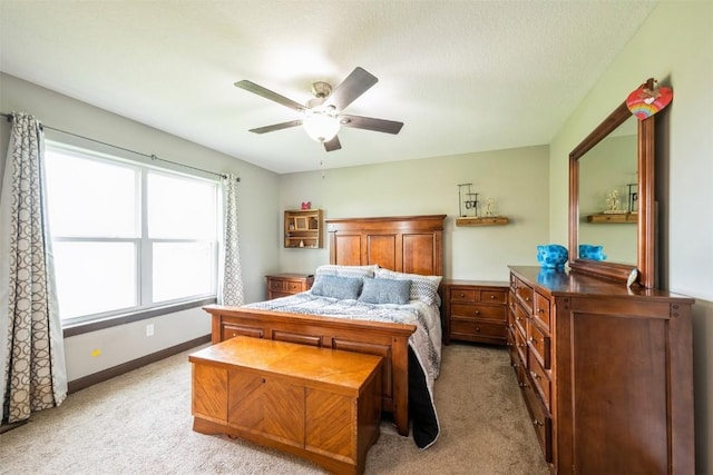 bedroom with light carpet, baseboards, and ceiling fan