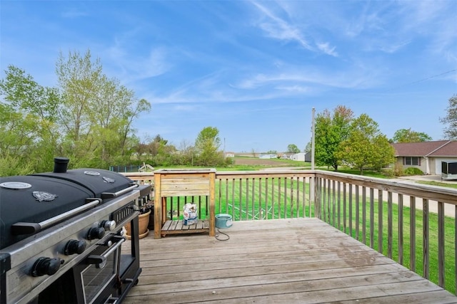 deck featuring a grill and a lawn