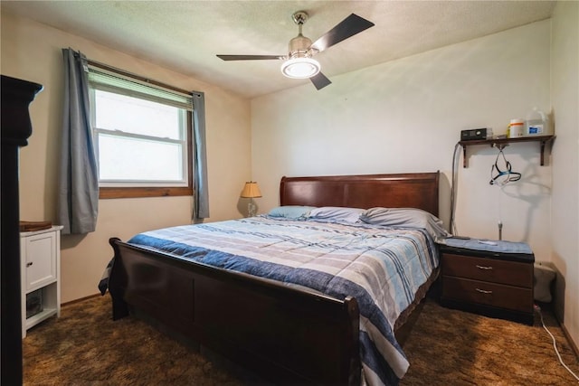 bedroom featuring dark carpet and ceiling fan