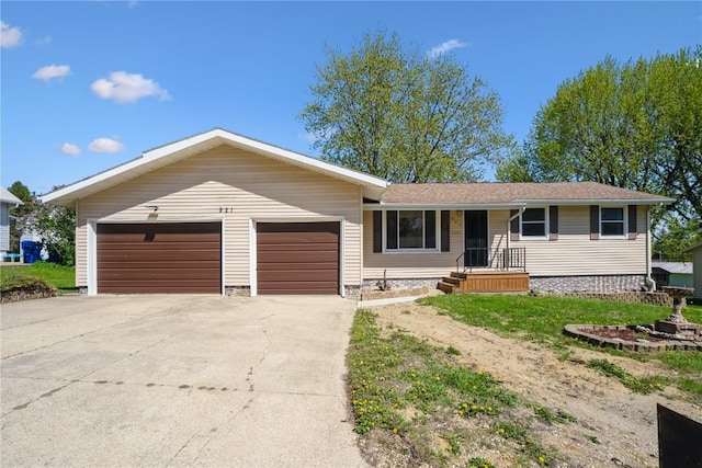 ranch-style house featuring an attached garage and driveway