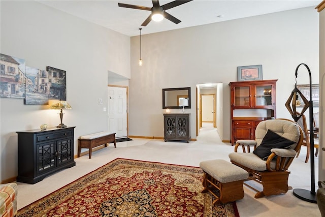 3110 Willowridge Rd Unit D, Marion, IA 52302 - living area with a ceiling fan, carpet floors, a high ceiling, and baseboards