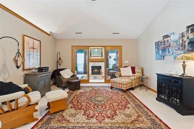 3110 Willowridge Rd Unit D, Marion, IA 52302 - carpeted living area featuring a warm lit fireplace and baseboards