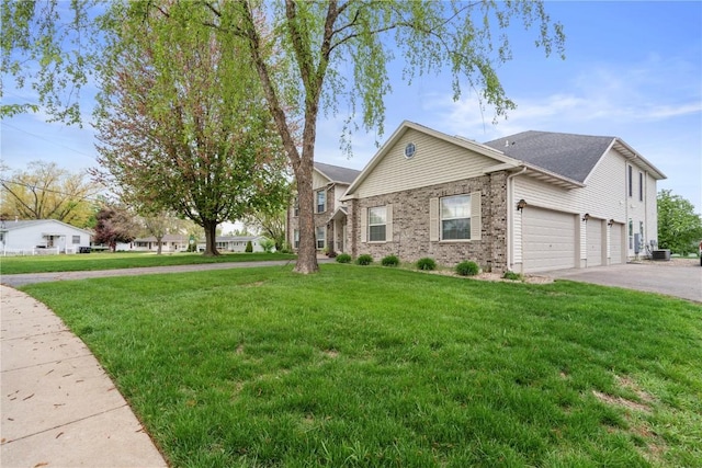 3110 Willowridge Rd Unit D, Marion, IA 52302 - view of front of home with asphalt driveway, a front yard, brick siding, and a garage