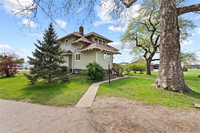 view of home's exterior with a chimney and a lawn