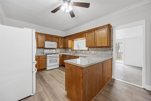 300 SW Palisades Rd, Mount Vernon, IA 52314 - kitchen with white appliances, plenty of natural light, and brown cabinetry