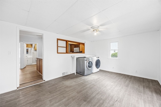 300 SW Palisades Rd, Mount Vernon, IA 52314 - clothes washing area with ceiling fan, washer and clothes dryer, wood finished floors, and baseboards
