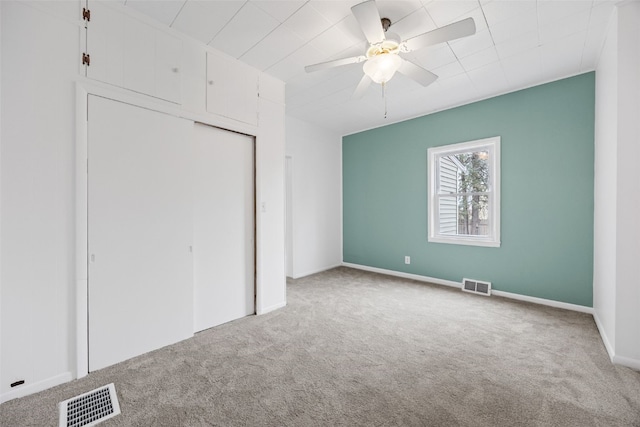 300 SW Palisades Rd, Mount Vernon, IA 52314 - unfurnished bedroom with carpet floors, a closet, and ceiling fan
