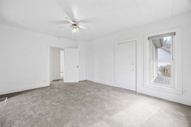 300 SW Palisades Rd, Mount Vernon, IA 52314 - unfurnished bedroom with carpet flooring, baseboards, and a ceiling fan