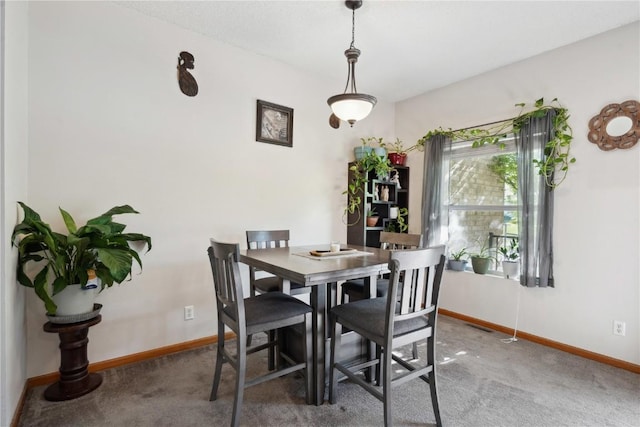 dining room with baseboards and carpet floors