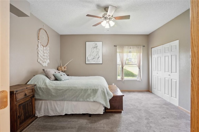bedroom with carpet floors, a closet, a textured ceiling, baseboards, and ceiling fan