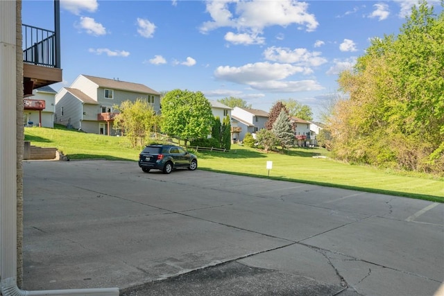 uncovered parking lot with a residential view
