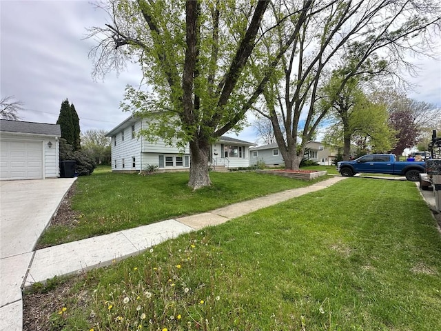 2770 24th Ave, Marion, IA 52302 - view of grassy yard featuring concrete driveway and a garage