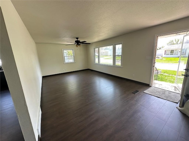 2770 24th Ave, Marion, IA 52302 - spare room with dark wood-style flooring, ceiling fan, and a textured ceiling