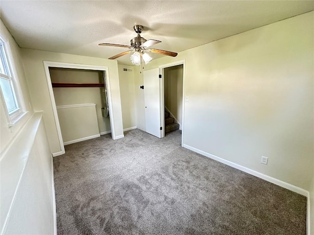 2770 24th Ave, Marion, IA 52302 - unfurnished bedroom featuring carpet, ceiling fan, a closet, and a textured ceiling