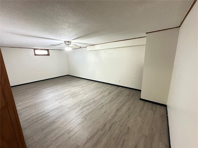 2770 24th Ave, Marion, IA 52302 - unfurnished bedroom featuring wood finished floors, a textured ceiling, and a ceiling fan