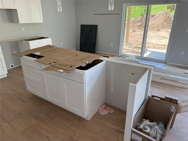 kitchen featuring light wood-style floors, white cabinetry, and a kitchen island