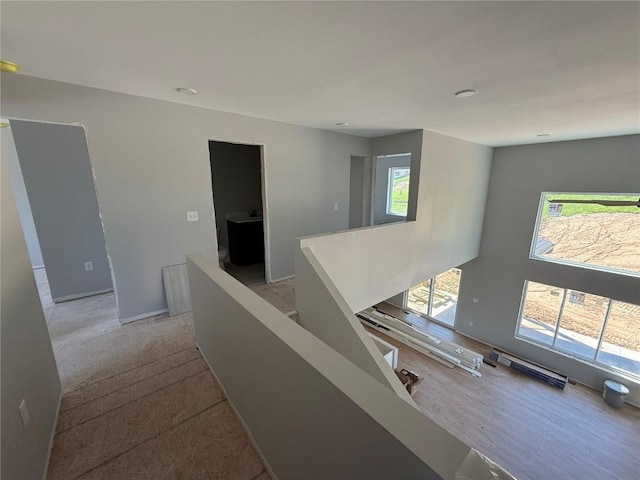 hall featuring an upstairs landing