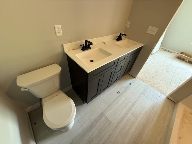 full bathroom with toilet and double vanity