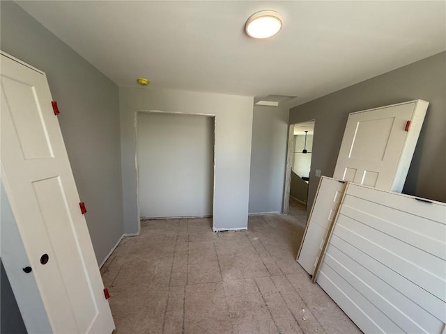 hallway featuring baseboards