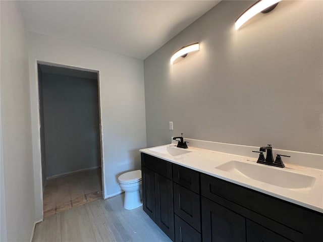 1301 Legend Dr, Tiffin, IA 52340 - full bath with wood finished floors, toilet, and double vanity