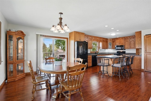 dining room with dark wood-type flooring, a chandelier, recessed lighting, and baseboards