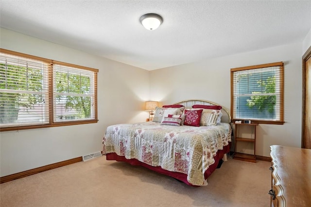 bedroom featuring carpet and baseboards