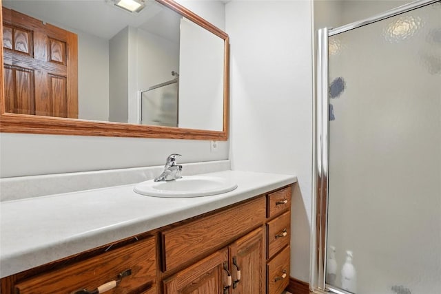 full bathroom with a stall shower and vanity