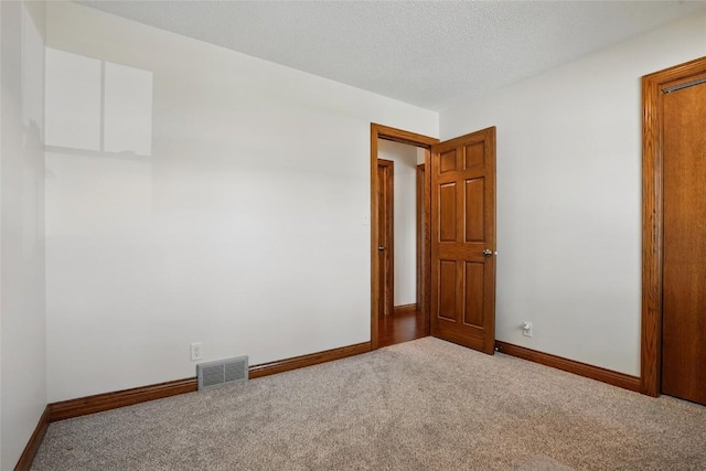 spare room featuring carpet flooring and baseboards