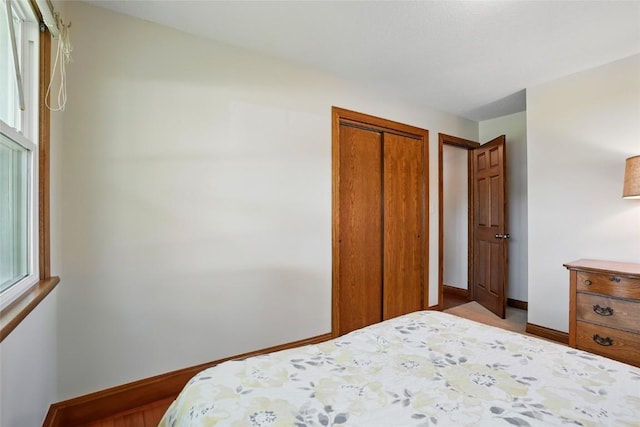 bedroom featuring a closet and baseboards