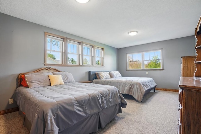 bedroom with carpet floors and baseboards