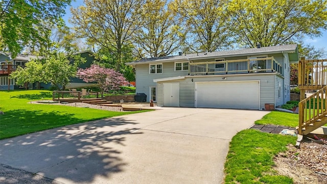 view of front of property with a front yard, an attached garage, driveway, and stairs