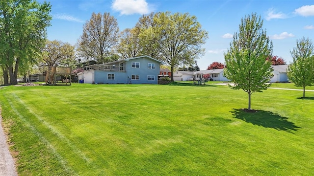 view of grassy yard featuring a wooden deck