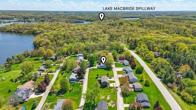 aerial view of residential area with a heavily wooded area and a large body of water
