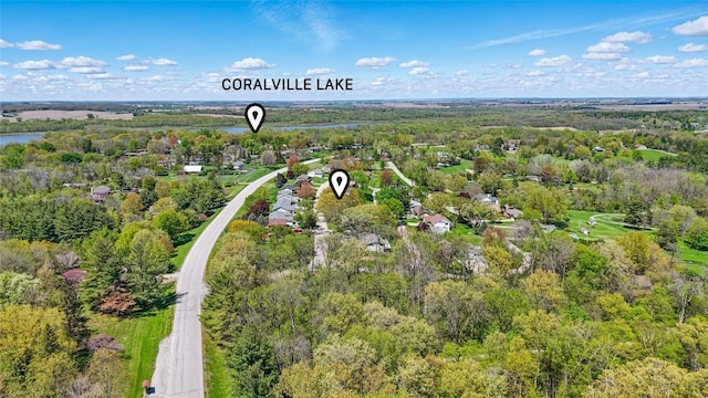 bird's eye view of a heavily wooded area and a large body of water