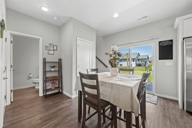dining area featuring dark wood finished floors, baseboards, and recessed lighting
