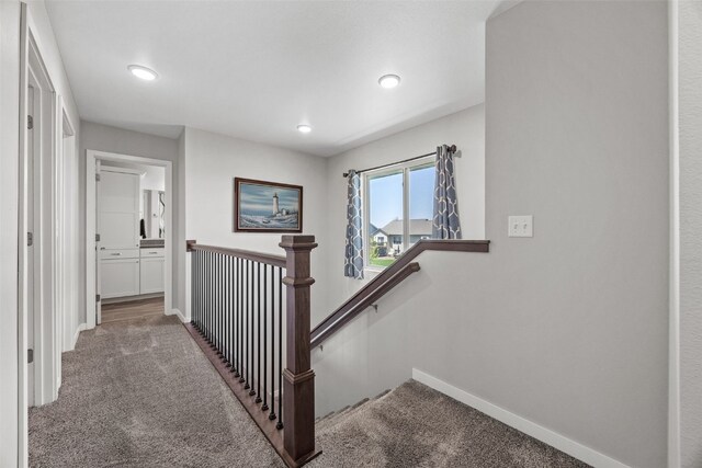 stairs featuring carpet floors, baseboards, and recessed lighting