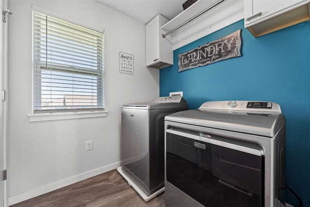 laundry room with independent washer and dryer, cabinet space, dark wood-type flooring, and baseboards