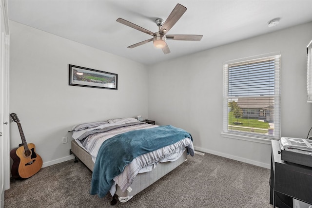 carpeted bedroom featuring baseboards and a ceiling fan