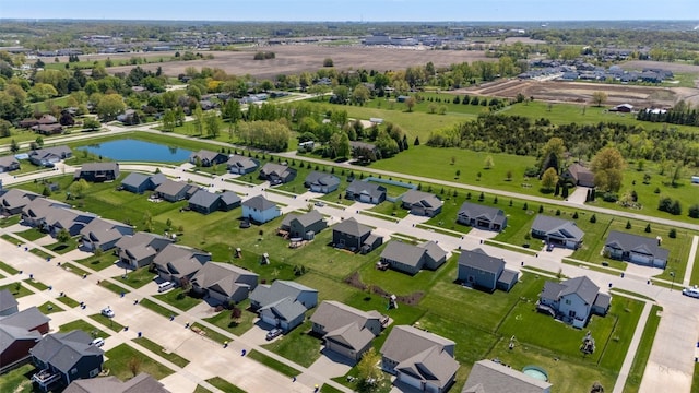 aerial view of property and surrounding area featuring a large body of water