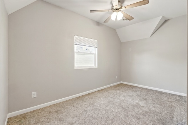 additional living space with lofted ceiling, carpet flooring, baseboards, and a ceiling fan