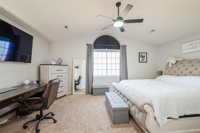 bedroom featuring light colored carpet, vaulted ceiling, an office area, and a ceiling fan