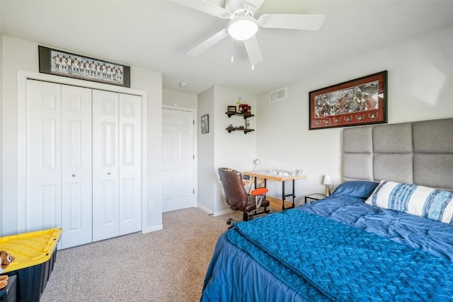 carpeted bedroom with a closet, baseboards, and ceiling fan