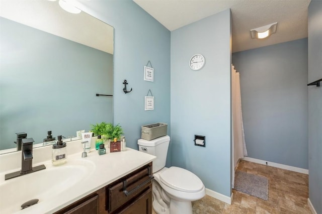 full bathroom with toilet, vanity, baseboards, and curtained shower