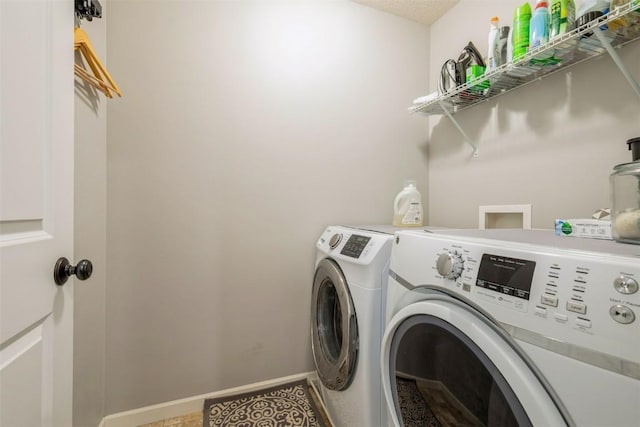 laundry area featuring washer and clothes dryer and baseboards