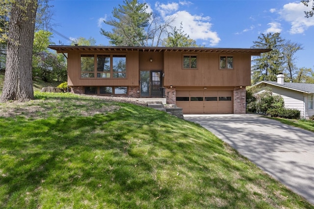3729 Wenig Rd NE, Cedar Rapids, IA 52402 - bi-level home with a garage, brick siding, concrete driveway, and a front yard
