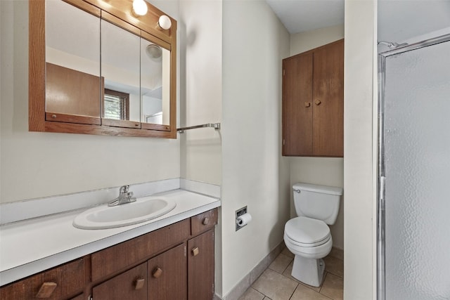 3729 Wenig Rd NE, Cedar Rapids, IA 52402 - bathroom featuring tile patterned floors, toilet, vanity, a shower with shower door, and baseboards