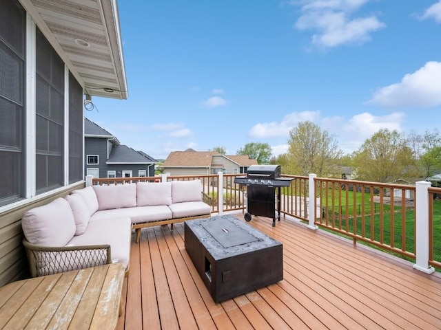 wooden deck with an outdoor living space with a fire pit and grilling area