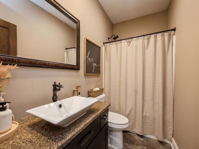 full bathroom with toilet, vanity, and curtained shower