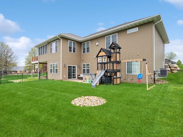 rear view of house with a playground and cooling unit